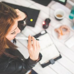 young woman studying over planner