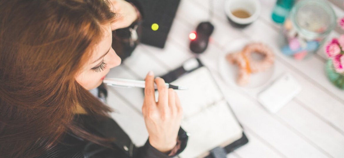 young woman studying over planner