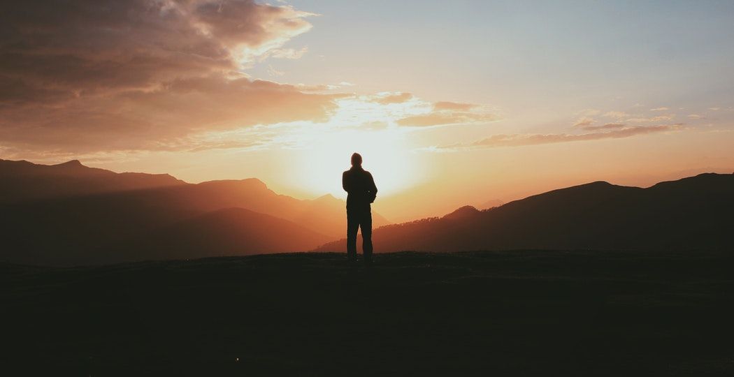 man looking at sunset